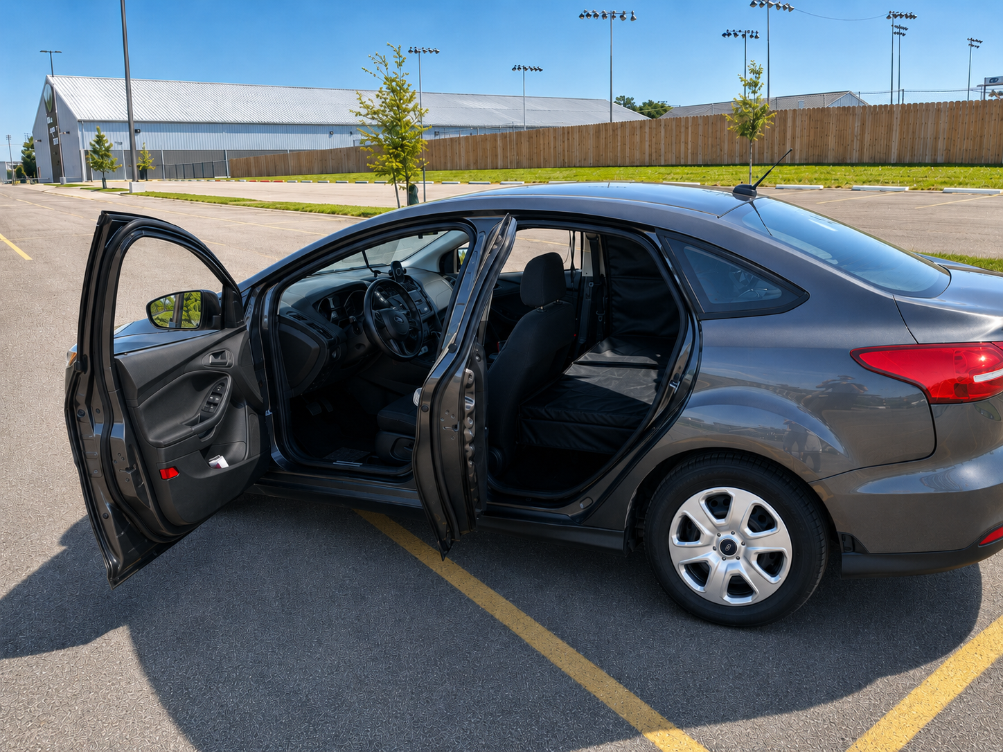 PupTaxi Comfort Cruiser modified Ford Focus with both doors open showing padded interior for dog transport
